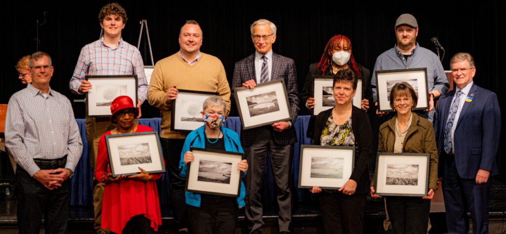 A group of people posing with awards.