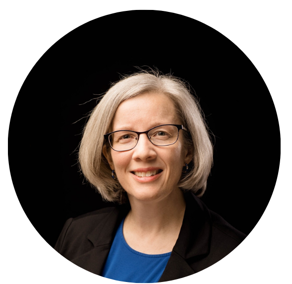 headshot of woman with short blond bob wearing glasses and smiling