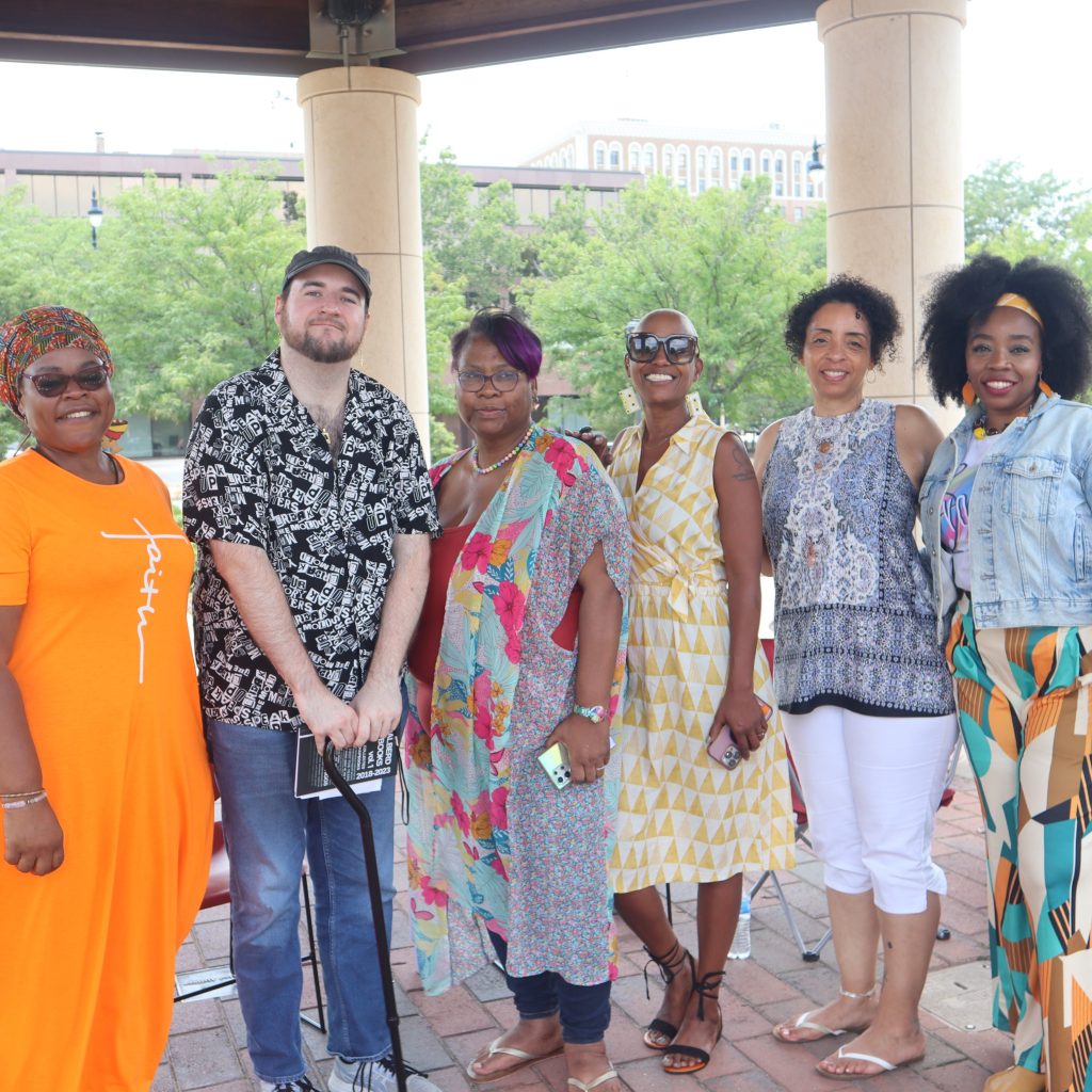 group of six people standing under a gazebo