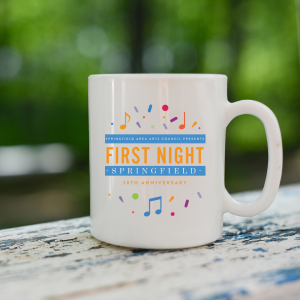 A white, ceramic mug with the 38th annual First Night Springfield logo, with colorful confetti and music notes sitting on a wooden railing with trees in the background.