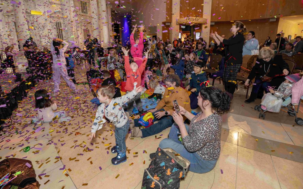 Group of people celebrating under falling confetti