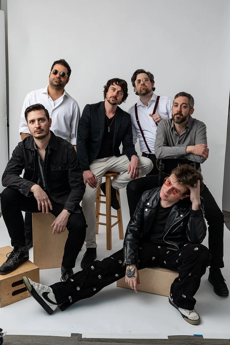 group of 6 men posing in a photography studio