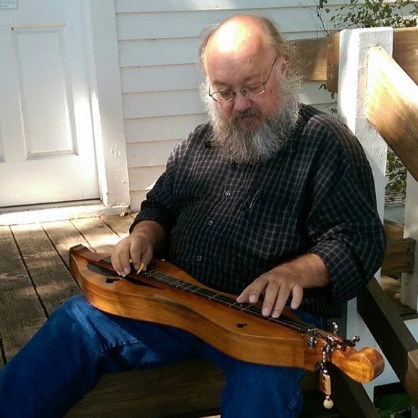 Man sitting with dulcimer in lap