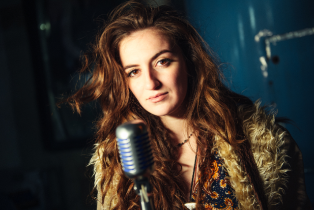 woman smiling in front of microphone