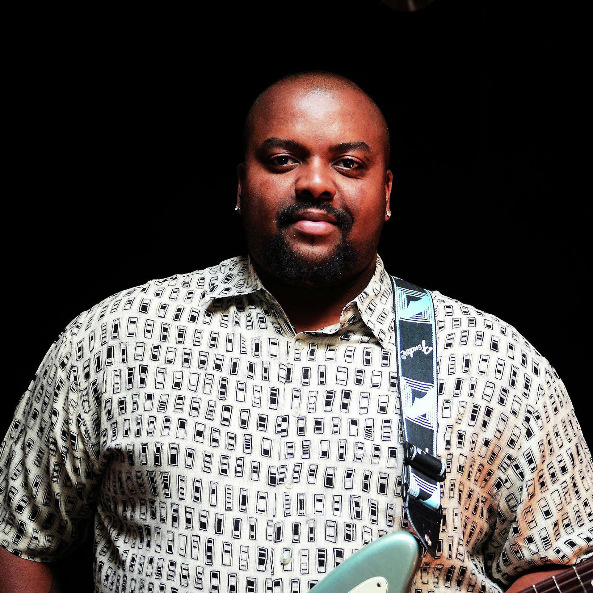 man posing with a guitar