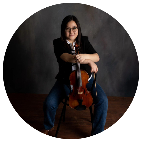 Asian woman sitting with violin in hand